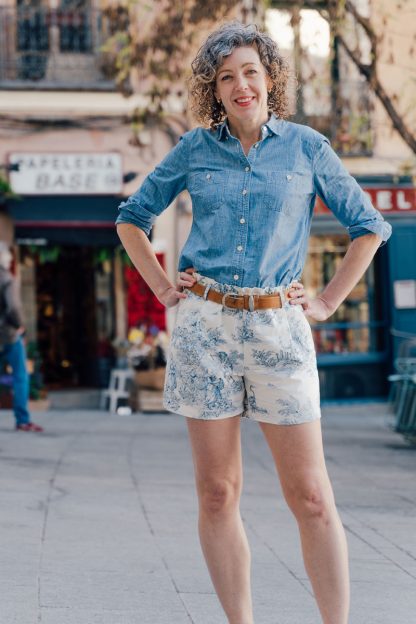 Woman wearing the Lisboa Walking Shorts sewing pattern from Liesl + Co on The Fold Line. A shorts pattern made in cotton poplin, twill, canvas, linen, wool suiting or wool flannel fabrics, featuring a pull-on style, elastic paper-bag waist, belt loops, front pockets and back welt pockets.