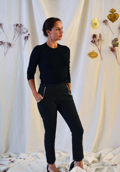 Woman wearing the Loulou Cigarette Pants sewing pattern from Maison Fauve on The Fold Line. A trouser pattern made in gabardine, denim, light wool, heavy viscose or jacquard fabrics, featuring a slim fit, geometric front pockets with piping and invisible side zipper.