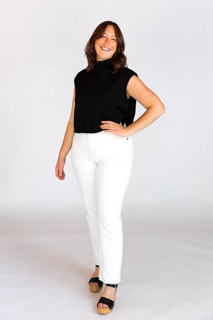 Woman wearing the Max Tee sewing pattern from Chalk and Notch on The Fold Line. A top pattern made in Jersey, French terry, sweater knit, rib knit, wool knit fabrics, featuring a cropped, boxy style, muscle tee shoulder shape, dropped armhole and mock neckband.