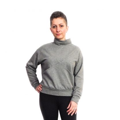 Women wearing the Maxine Sweater sewing pattern from Dhurata Davies Patterns on The Fold Line. A sweater pattern made in medium to heavy weight stretch fabrics, featuring a criss-cross front detail, front pockets, turtle neck, drop shoulder, ribbed waistband and cuffs.