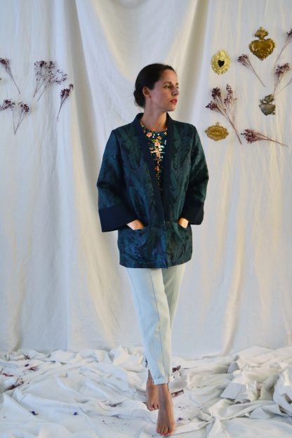 Woman wearing the Sable Jacket sewing pattern from Maison Fauve on The Fold Line. A jacket pattern made in lightweight wool, denim, gabardine or thicker cotton fabrics, featuring a robe-like collar and sleeves with blazer silhouette, front pockets and no closures.