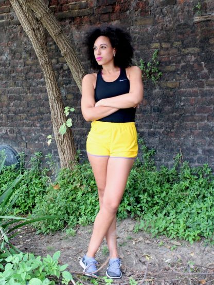Woman wearing the Threshold Shorts sewing pattern from Fehr Trade on The Fold Line. A running shorts pattern made in Dri-FIT, Coolmax, or lightweight woven nylon fabrics, featuring three optional pockets, curved seamlines, bound hem, and elastic waist.