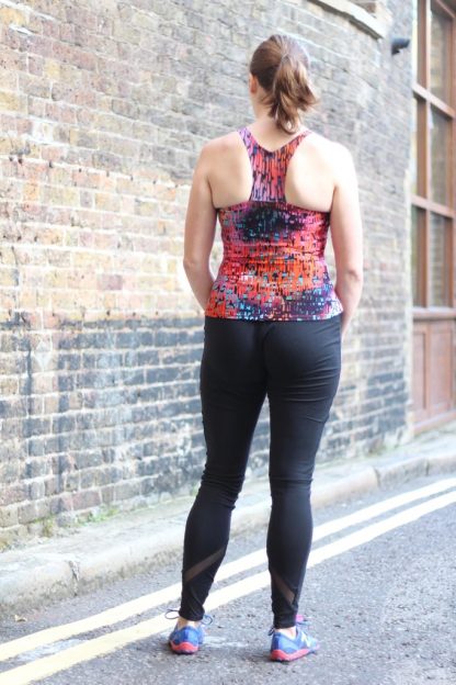 Woman wearing the XYT Workout Top sewing pattern from Fehr Trade on The Fold Line. A workout top pattern made in lycra jersey fabrics, featuring a close-fit, sleeveless, front scoop neck, racerback, optional built-in bra, elasticated or bound neck and armhole edges.