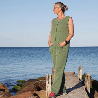 Woman wearing the Aviator Jumpsuit sewing pattern from Wardrobe by Me on The Fold Line. A jumpsuit pattern made in linen, cotton, denim, canvas or twill fabrics, featuring a relaxed-fit, round neckline, patch pockets, full length legs and no sleeves.