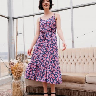 Woman wearing the Chloe Sundress sewing pattern from Atelier Jupe on The Fold Line. A sundress pattern made in viscose, tencel, cotton or linen fabrics, featuring spaghetti shoulder straps, cross back straps, elasticated back, bust darts, tiered hem and midi length.