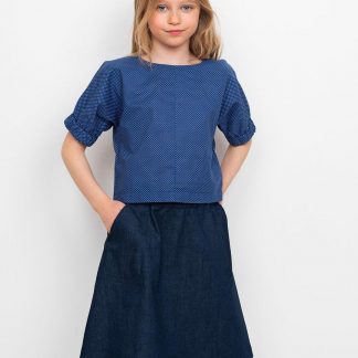 Child wearing the Children's Cuff Top Mini sewing pattern from The Assembly Line on The Fold Line. A top pattern made in light to mid-weight fabrics, featuring a straight fit, round neck, keyhole opening with snap fastener at the back and cap sleeves with wide elastic cuffs.