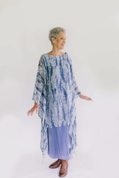 Woman wearing the 266 Greek Island Dress sewing pattern from Folkwear on The Fold Line. A sheath dress pattern made in chiffon, georgette, gauze, voile or novelty cut velvet fabrics, featuring a front and back sailor collar, floating sleeve panels and knee length finish.
