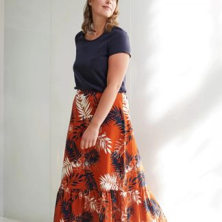 Woman wearing the Lottie Skirt sewing pattern from Atelier Jupe on The Fold Line. A skirt pattern made in viscose or tencel fabrics, featuring a bottom ruffle, elasticated back waistband and maxi length.