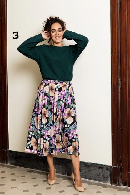 Woman wearing the Stina Skirt sewing pattern from Atelier Jupe on The Fold Line. A skirt pattern made in viscose, tencel, cotton, linen or polyester fabrics, featuring inverted pleats, side seam pockets mid-length finish and elasticated waistband.