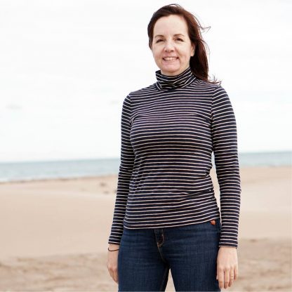 Woman wearing the Trudy Turtleneck sewing pattern from Wardrobe by Me on The Fold Line. A fitted top made in light to medium weight jersey fabrics, featuring a turtleneck, full length sleeves and straight hem.