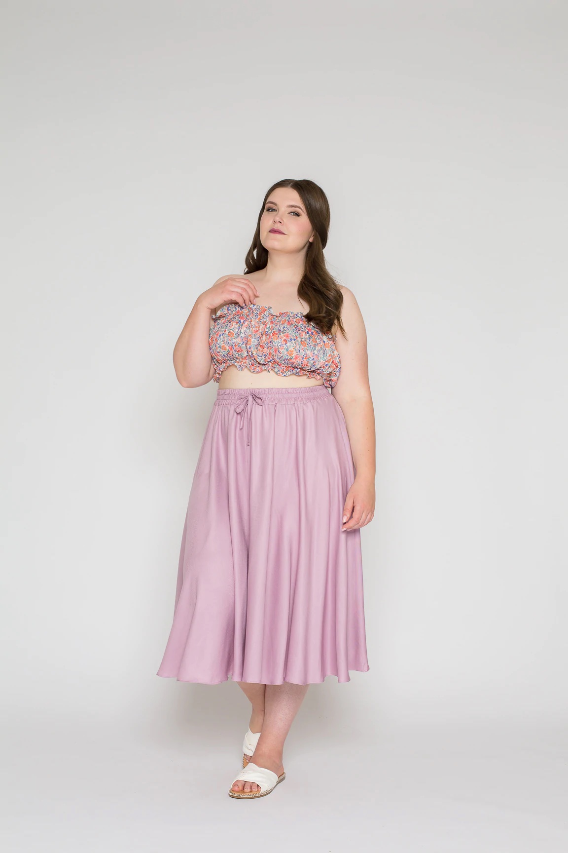 Woman wearing the Juni Skirt sewing pattern from Bara Studio on The Fold Line. A skirt pattern made in viscose, cotton, linen or tencel fabrics, featuring a gathered midi skirt with elastic waistband and tie.