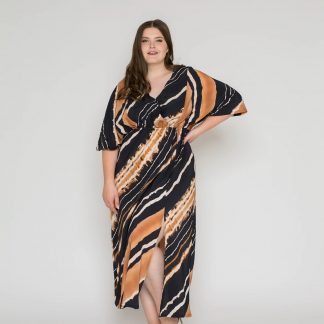 Woman wearing the Leana Caftan sewing pattern from Bara Studio on The Fold Line. A dress pattern made in viscose, cotton, linen or tencel fabrics, featuring a relaxed fit, elasticated waist, wide mid-length sleeves, front slit, V-neck and midi length.