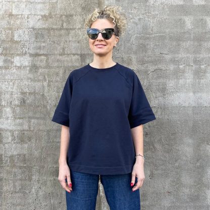 Women wearing the Myka Top sewing pattern from Tessuti Fabrics on The Fold Line. A t-shirt pattern made in cotton/elastane French terry or firm knit jersey fabrics featuring an oversized boxy fit, high round neckline, self-fabric neck band, loose elbow-length raglan sleeves, shoulder darts, wide sleeve bands and deep hem.