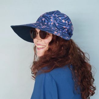 Woman wearing the Sunni Hat sewing pattern from Melilot on The Fold Line. A hat pattern made in linen or cotton fabrics featuring a broad peak with full coverage.
