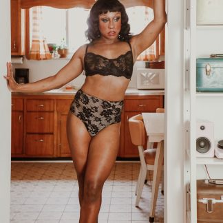 Model wearing the Adrian Transgender Bra and Panty sewing pattern from Madalynne on The Fold Line. A transgender bra and panty pattern made in 8 – 20% spandex fabrics, featuring a bra with a full band, underwire, scalloped lace edges on the upper cups, hook and eye closure at the centre back and adjustable shoulder straps. Panties are basic, high-waist, with extended gusset.