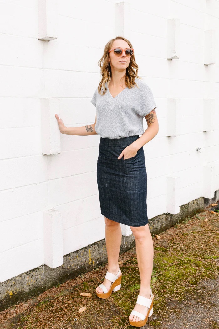 Woman wearing the Alberta Street Pencil Skirt sewing pattern from Sew House Seven on The Fold Line. A pencil skirt pattern made in denim, canvas, corduroy, twill, gabardine, poplin, sateen or stretch woven fabrics, featuring a slim fit, no ease at the hips, tapered to knee length hem, contoured waistband, front patch pockets, double back darts, back vent and centre back zipper.