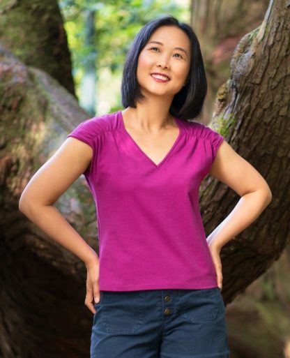 Woman wearing the Soller Top sewing pattern from Itch to Stitch on The Fold Line. A knit top pattern made in medium weight knit fabrics, featuring shoulder gathers, grown on very short sleeves and a V-neck.