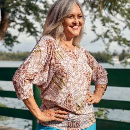 Woman wearing the Wanda Tunic Top sewing pattern from Sirena Patterns on The Fold Line. A top pattern made in nylon spandex, poly spandex, cotton spandex fabrics, featuring a dolman sleeve, scoop neck with neck binding and relaxed fit.