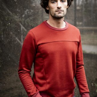 Man wearing the Calvin Jumper sewing pattern from Fibre Mood on The Fold Line. A jumper pattern made in sweatshirting, French terry or neoprene fabrics, featuring ribbed waistband and cuffs, round neck, and additional front seaming.