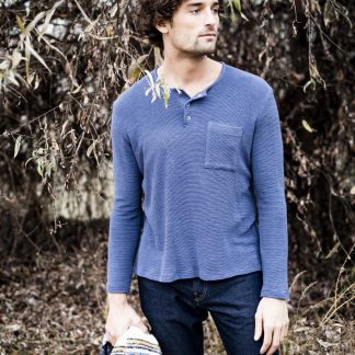 Man wearing the Hugo T-shirt sewing pattern from Fibre Mood on The Fold Line. A T-shirt pattern made in cotton, viscose or wool knit jersey fabrics, featuring a crew neck, long sleeves, chest patch pocket and polo-style snap placket.