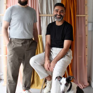 Men wearing the Men’s Everyday Trousers sewing pattern from The New Craft House on The Fold Line. A trouser pattern made in cotton, linen, lightweight denim, satin or silk fabrics, featuring a slightly tapered leg, wide elasticated waistband, mid-rise, faux fly and side pockets.