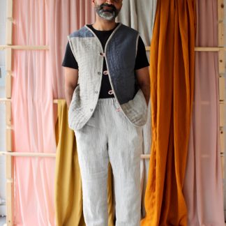 Man wearing the Men’s Everyday Waistcoat sewing pattern from The New Craft House on The Fold Line. A waistcoat pattern made in cotton, linen or double gauze fabrics, featuring button and loop closure, two front patch pockets and a V-neck