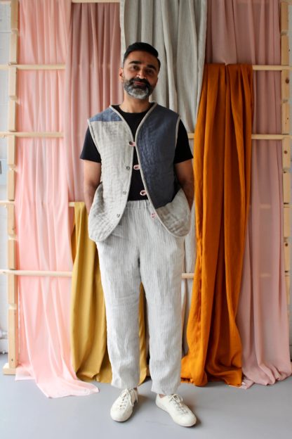 Man wearing the Men’s Everyday Waistcoat sewing pattern from The New Craft House on The Fold Line. A waistcoat pattern made in cotton, linen or double gauze fabrics, featuring button and loop closure, two front patch pockets and a V-neck