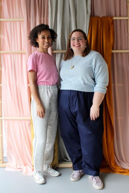Women wearing the Women's Everyday Trousers sewing pattern from The New Craft House on The Fold Line. A trouser pattern made in lightweight denim, cotton, linen, satin or silk fabrics, featuring a slightly tapered full length leg, wide elasticated waistband, high waist, faux fly and side pockets,
