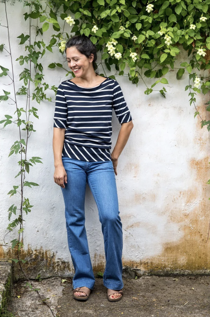 Woman wearing the Anegada Boat Neck Top sewing pattern from Halfmoon Atelier on The Fold Line. A top pattern made in jersey, bamboo or rayon jersey, interlock, T-shirt weight merino, French terry or lightweight sweatshirting fabrics, featuring a semi-fit, relaxed boat neckline resulting in a cowl effect, elbow length sleeves and deep hem and cuff bands.