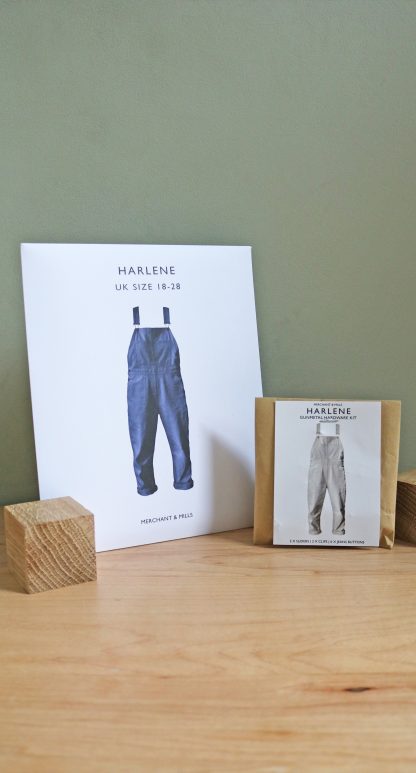 Photo showing the Merchant & Mills Harlene Pattern and Hardware Kit Bundle. Dungarees are a fun sewing project and this gift bundle includes the sewing pattern plus all the hardware you need. A classic easy to fit style making this bundle the perfect gift or present.