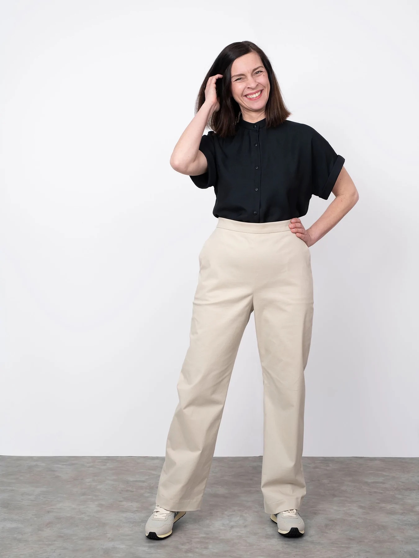Woman wearing the Regular Fit Trousers sewing pattern from The Assembly Line on The Fold Line. A trouser pattern made in mid weight fabrics, featuring a high waist, straight, full-length legs, side slant pockets, left side zipper opening.