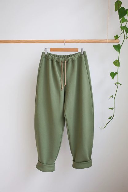 Photo showing the Sunday Trackies sewing pattern from The Modern Sewing Co on The Fold Line. A tracksuit trouser pattern made in sweatshirt fleece jersey or french terry fabrics, featuring an elasticated waist with drawstring, relaxed fit, high waisted, full length leg with ankle cuffs and curved back patch pocket.