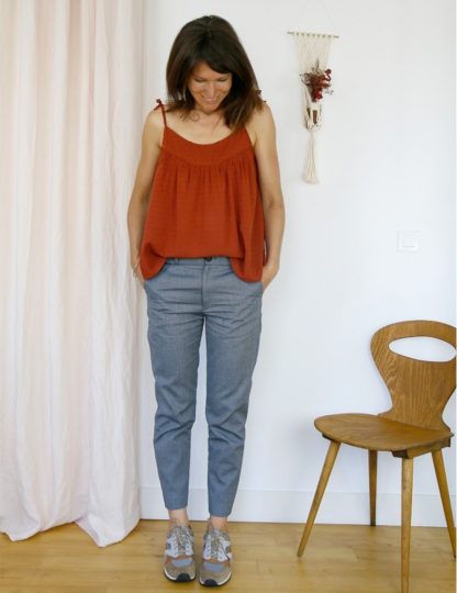 Woman wearing the Crépuscule Tank Top sewing pattern from Atelier Scämmit on The Fold Line. A strappy top pattern made in batiste, chiffon, veil, crepe or viscose fabrics, featuring spaghetti tie straps, low rounded neckline, gathered yoke and relaxed fit.