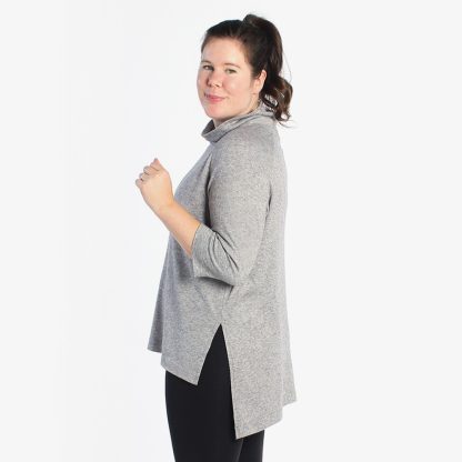 Woman wearing the Elliot Sweater and Tee sewing pattern from Helen's Closet on The Fold Line. A sweater pattern made in sweater knits with at least 20% stretch widthwise and 10% stretch lengthwise fabrics featuring a high-low hem with side slit, raglan sleeves, relaxed fit, and medium high rolled neck.