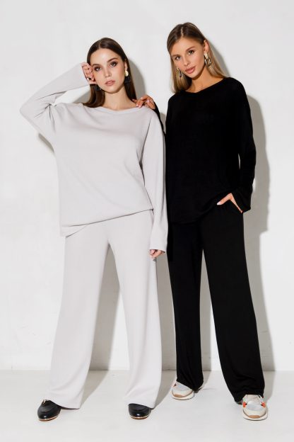 Women wearing the Ruta Pants sewing pattern from Vikisews on The Fold Line. A trouser pattern made in sweater knit fabrics, featuring a semi-fit, straight-cut, side seam pockets, elasticated waistband and floor length.
