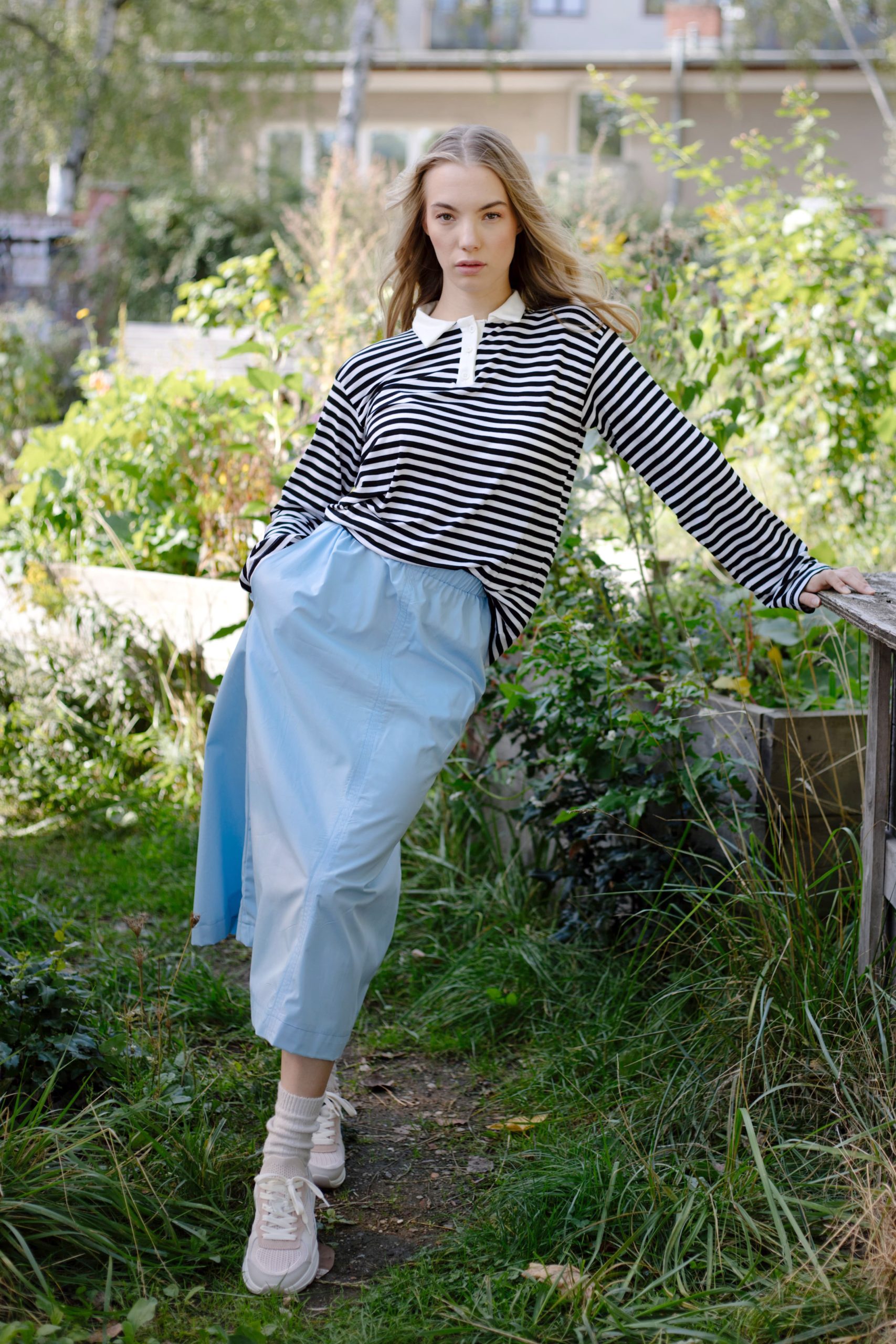 Woman wearing the Holly Skirt sewing pattern from JULIANA MARTEJEVS on The Fold Line. A skirt pattern made in cotton poplin fabrics, featuring a midi length, elastic waistband, in-seam pockets and relaxed fit.