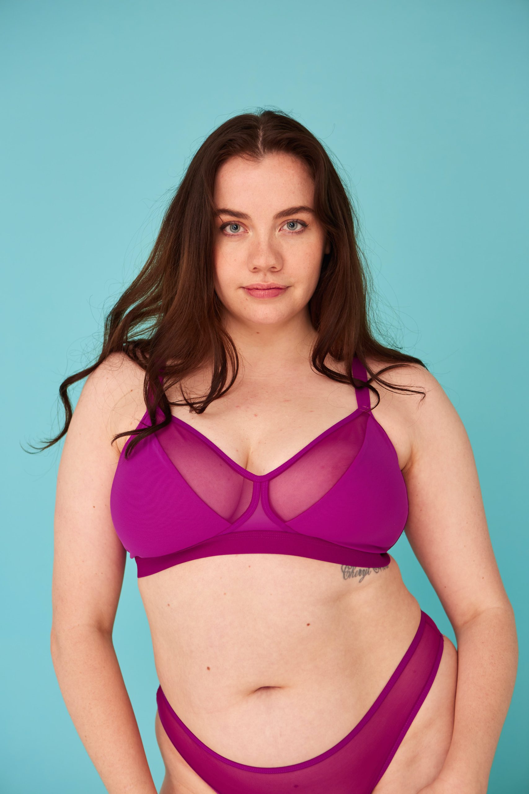 Woman wearing the Ava Bra sewing pattern from The New Craft House on The Fold Line. A bra pattern made in stretch mesh, cotton jersey, lingerie jersey and lace fabrics, featuring a soft cup triangular bra, under band, adjustable slider shoulder straps, adjustable hook and eye back clasp.
