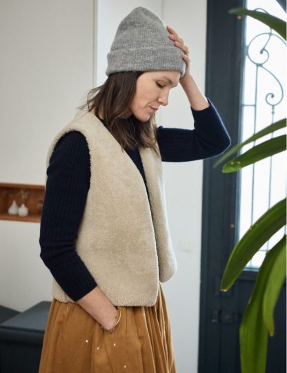 Woman wearing the Berger Gilet sewing pattern from Atelier Scämmit on The Fold Line. A Gilet pattern made in woollen or jacquard fabrics, featuring a V-neckline, no closures, and straight hem.