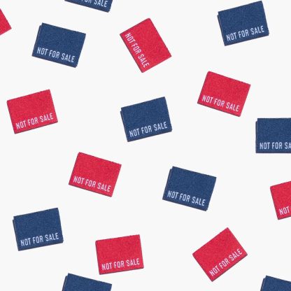 Photo showing 'Not for Sale' Woven Labels from Kylie & The Machine on The Fold Line. A washable, durable, and non-scratchy fabric label featuring red or blue coloured backgrounds with white text, they are all ready to be sewn into your handmade clothes.