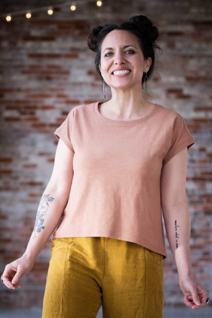 Woman wearing the Bedrock Tee sewing pattern from Sew Liberated on The Fold Line. A T-shirt pattern made in knit fabrics, featuring a boxy fit, below waist length, dropped shoulder, slightly curved hemline and short sleeves.