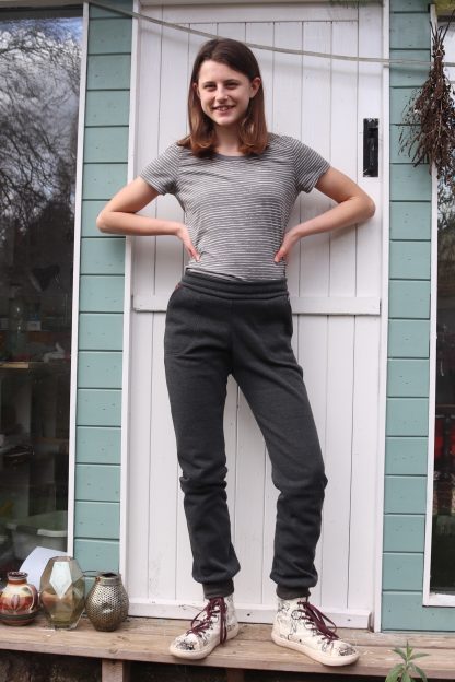 Child wearing the Teen Girls' Field Trip Joggers sewing pattern from Waves & Wild on The Fold Line. A joggers pattern made in stretch knit fabrics, featuring a relaxed fit, hip pockets and elasticated waist.