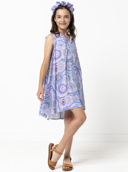 Child wearing the Child/Teen Heidi Dress sewing pattern from Style Arc on The Fold Line. A dress pattern made in rayon, silk, or voile fabrics, featuring a free-flowing style, neckline gathers, front neck ties, deep gathered armholes and a high-low hemline.