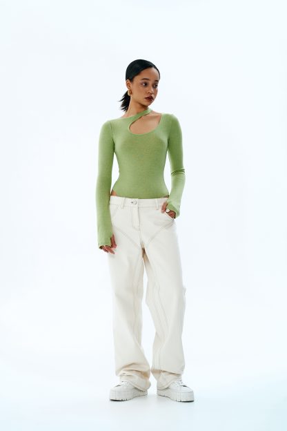 Woman wearing the Jewel Pants sewing pattern from Vikisews on The Fold Line. A trouser pattern made in denim or corduroy fabrics, featuring a loose-fit, straight-cut, topstitching, belt loops, faux side pockets, back yoke with patch pockets, fly front zipper closure, and floor-length.