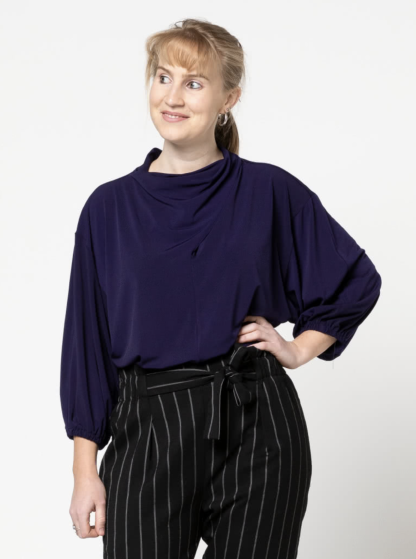 Woman wearing the Lucia Knit Top sewing pattern from Style Arc on The Fold Line. A Knit Top pattern made in silk jersey, or knit fabrics, featuring a twisted cowl neck, dropped shoulder, 3/4 length sleeves, elasticated sleeve hem and relaxed fit.