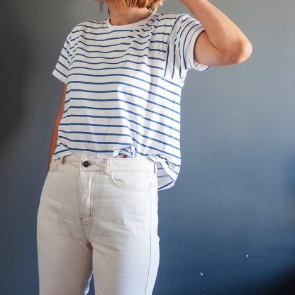 Woman wearing the Tarifa Tee sewing pattern from French Navy on The Fold Line. A T-shirt pattern made in light to medium weight cotton/spandex knit fabrics, featuring a relaxed boxy style, round neck, short sleeves and high/low hemline,
