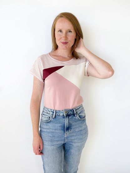 Woman wearing the Emmie Tee sewing pattern from Jennifer Lauren Handmade on The Fold Line. A T-shirt pattern made in medium weight knit fabrics, featuring a slashed and pieced bodice with grown-on sleeves and rounded neckline.