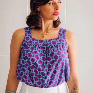 Woman wearing the Salto Top sewing pattern from Maison Fauve on The Fold Line. A top pattern made in cotton, viscose poplin, jacquard, viscose crepe, twills, tencel, or broderie anglaise fabrics, featuring a square neckline, sleeveless, broad shoulder straps and front button closure.