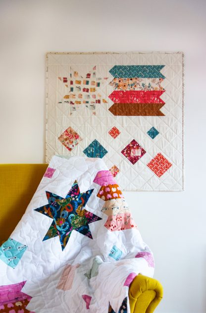Photo showing the Shooting Stars Quilt sewing pattern from Lou Orth Designs on The Fold Line. A quilt pattern made in quilting cotton fabrics, featuring a fun star pattern that looks beautiful in any fabric.