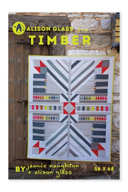 Photo showing the Timber Quilt sewing pattern from Alison Glass on The Fold Line. A quilt pattern made in quilting cotton fabrics. Featuring a pattern inspired by half-timbered architecture, it is a modern block-based design.