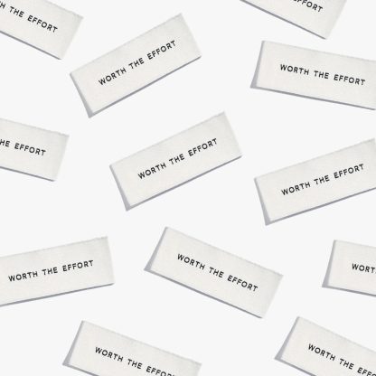 Photo showing 'Worth the Effort' Cotton Labels from Kylie & The Machine on The Fold Line. A washable, durable, and non-scratchy cotton label featuring white coloured backgrounds with black text, they are all ready to be sewn into your handmade clothes.